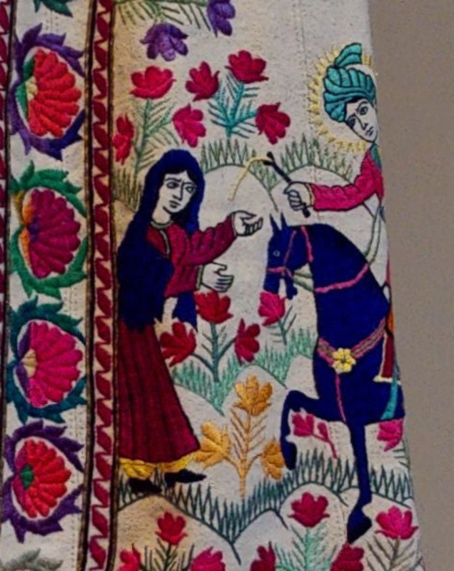 Side view of the Aga Khan Museum's PS24, Robe. Embroidered illustration of Sultan Sanjar and the Old Woman. Depicts a scene from the Treasury of Secrets epic poem written in the Shahnameh. 